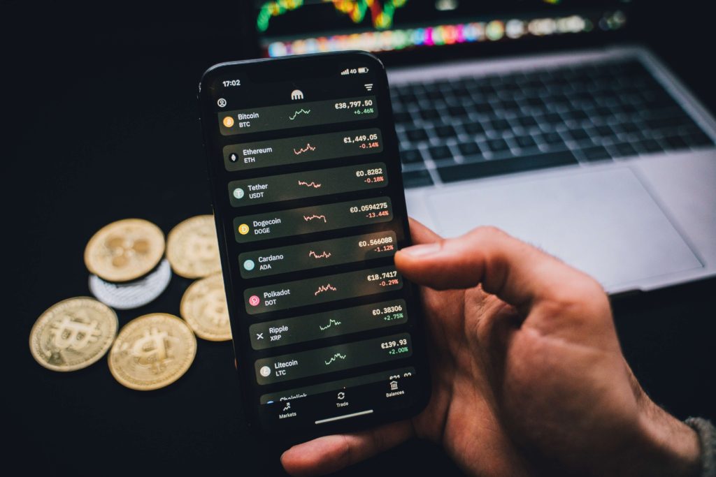 Man using a phone to get the best crypto newbie tips for Investing tips for newbies in the crypto world.