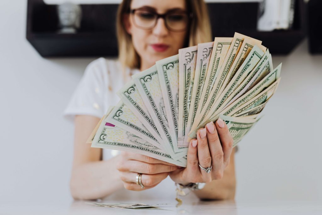 Lady counting the amount of money she earn from her robinhood sign bonus