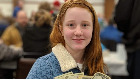 A red hair teenager happy about making money