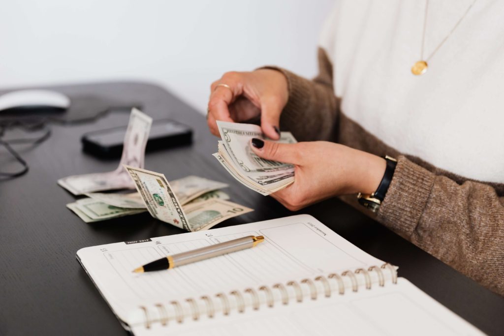 A teenager female counting her money