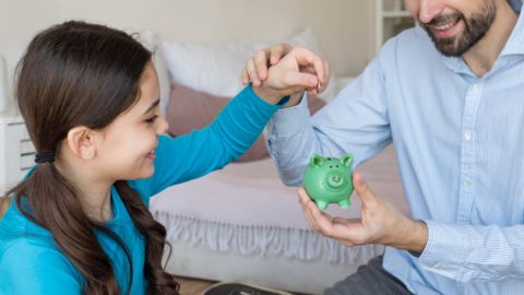 Father's day investments lesson-Father teaching financial literacy to his child on Father's Day