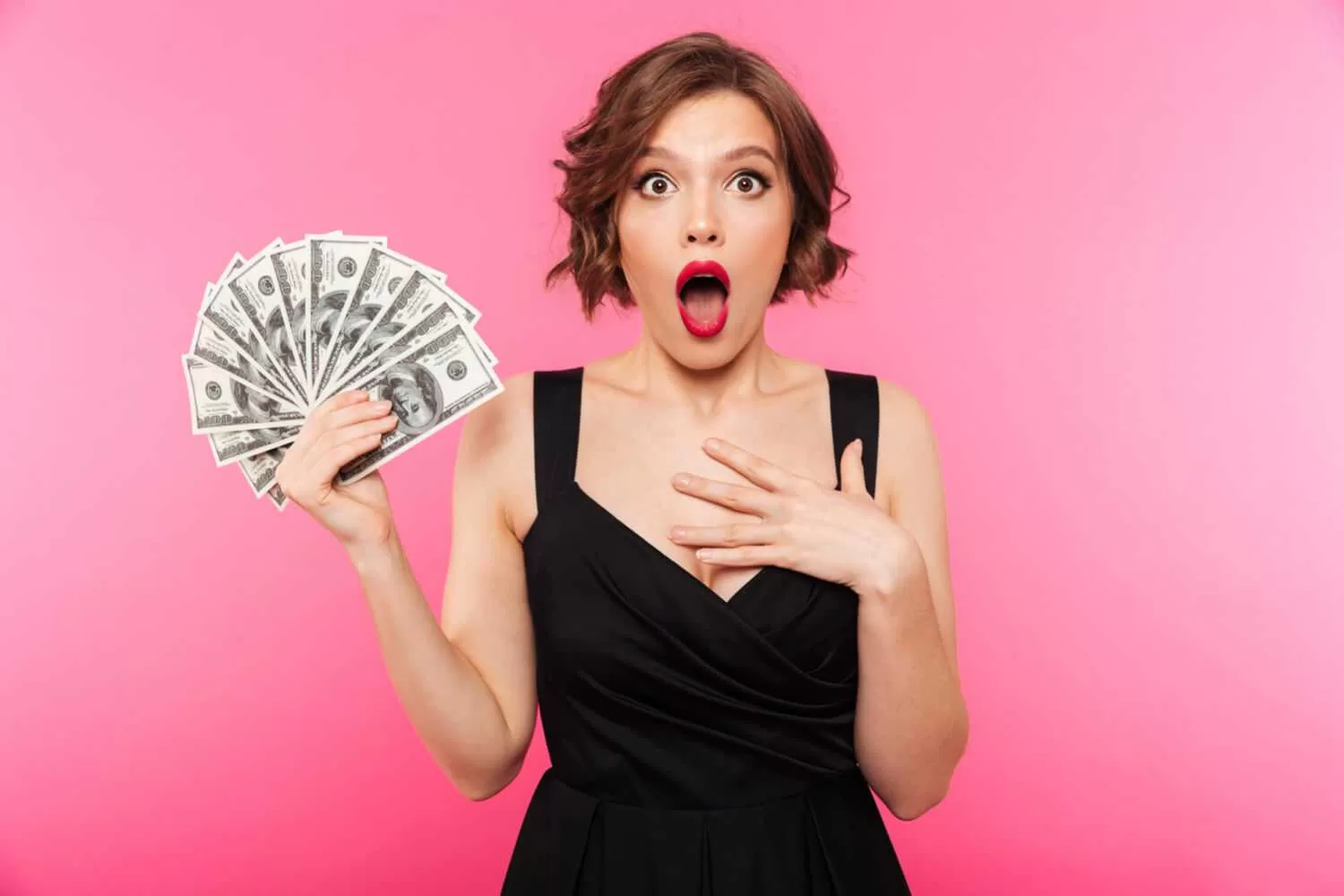 A woman holding a bunch of money in shock. Overcome the control of the Central Bank Digital Currency and start making money like her
