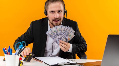 Man showing off money from following the 10 Steps to Financial Success